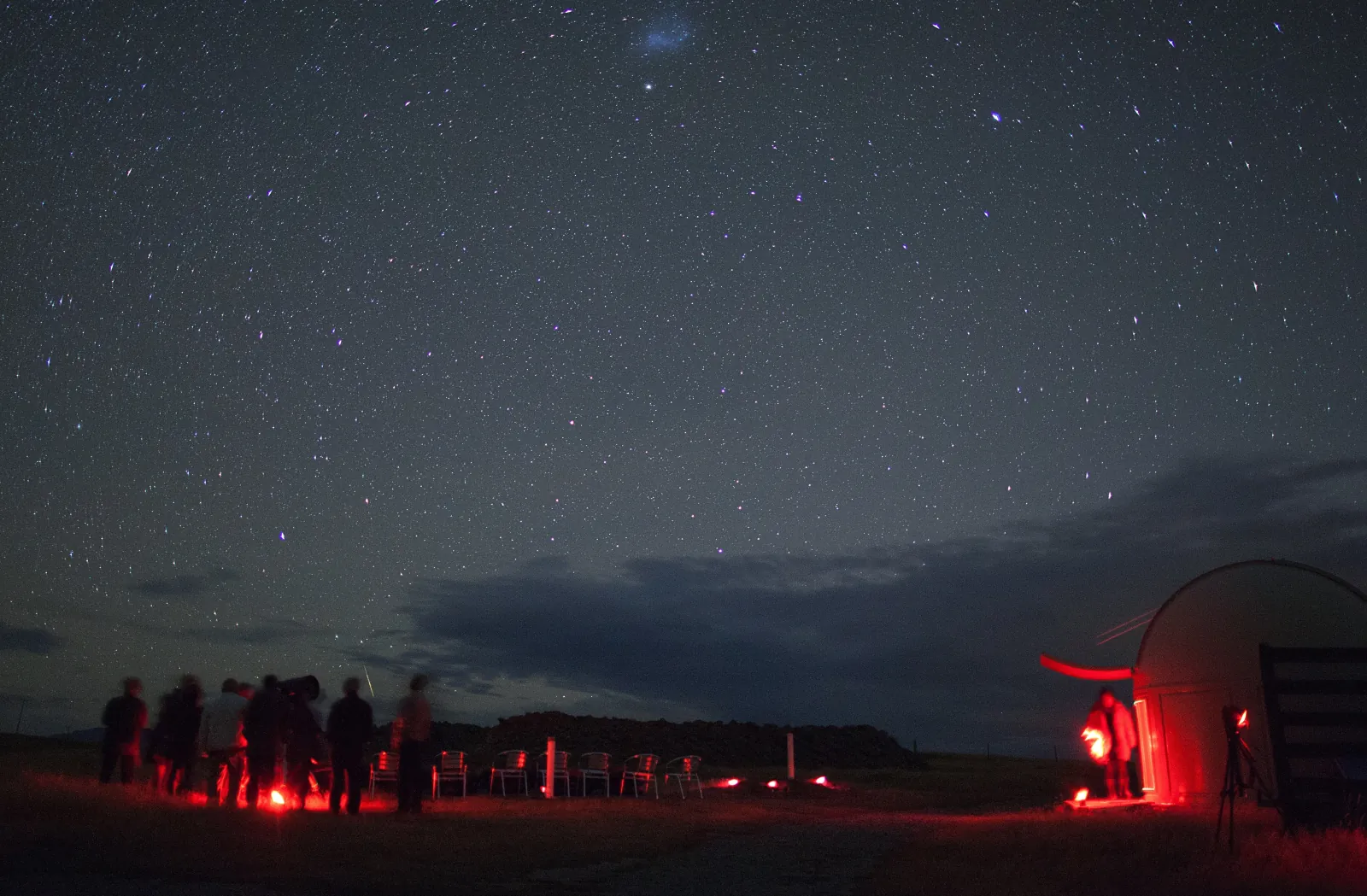 Guests at the observatory dome beneath a starry sky near Tekapo