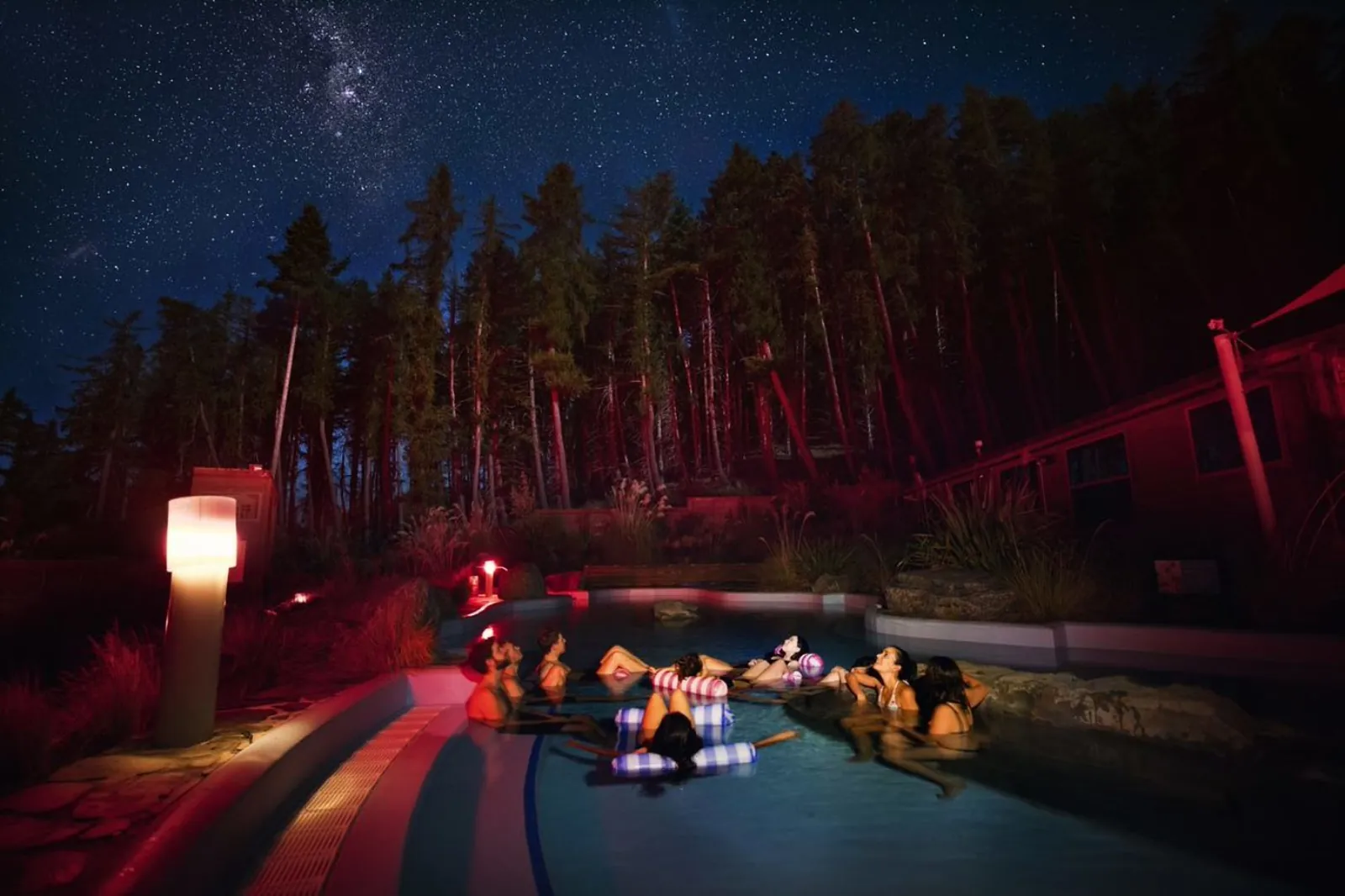 Tekapo Springs pools surrounded by pine trees at night