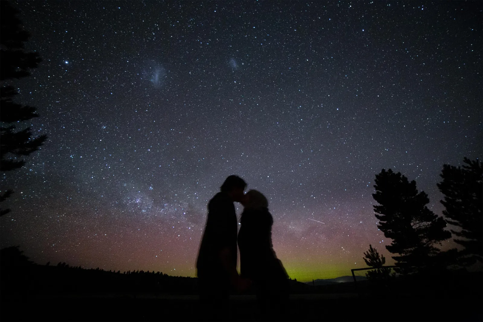 Couple silhouetted against the night sky at the Tekapo stargazing site